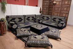 an ornately decorated couch sits in the middle of a room