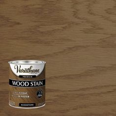 a can of wood stain sitting on top of a wooden floor