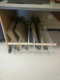 several stacks of folders sitting on top of a shelf