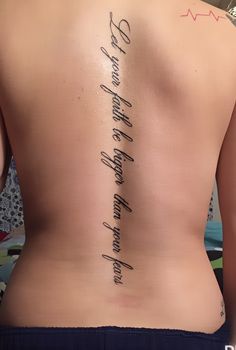 the back of a woman's upper body with writing on her lower back and side