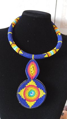 African Beaded Pendant Necklace,  Zulu Necklace, African Jewelry, Women Jewelry, Gift for her, Tribal necklace, Moms GiftThis pendant  necklace is superbly crafted.Main Color - Dark blue.Different colors can be available.Feel free to send me a convo or e-mail for any clarification or more information.Thank you for visiting and happy shopping! Traditional Blue Beaded Jewelry, Traditional Blue Necklace, Traditional Blue Choker With Colorful Beads, Traditional Blue Beaded Choker, Traditional Blue Round Beads Necklace, Traditional Blue Round Beaded Necklaces, Bohemian Blue Necklace With Black Beads, Blue Beaded Chain Jewelry, Blue Beaded Round Jewelry