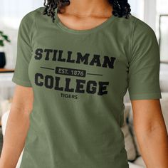 Custom & Vintage Stillman Tigers HBCU College Apparel, Graphic Tees, Hoodies, Sweatshirts, and More Stillman Apparel For Both Stillman Students and Stillman Alumni. Black owned, HBCU alumni operated apparel company specializing in academic wear. This Stillman Tigers product is handmade in Atlanta, GA with materials purchased from local Atlanta vendors. We use only the best material, printing, and packaging. Orders typically ship much faster than posted timeframes.  DOES NOT come in Ladies/Women's Fit; currently out of stock. We Use Bella + Canvas (B6400) 100% Ringspun Cotton and Gildan (G500) 100% Cotton Shirts. Gildan is the default for every item. We've ensured that both models are the same width, length, and chest. There are dozens of models for each brand but those two are the most con Fitted Green Tops For College, Cotton College Tops With Branding, Branded Cotton Tops For College, Fitted Cotton Collegiate T-shirt, Stretch Cotton T-shirt For College, Cotton Stretch T-shirt For College, Hbcu Colleges, Packaging Orders, College Apparel