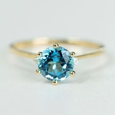 Valentine's gift: Swiss Blue Topaz engagement ring gold, ring for women. Gift for her Gemstone rings: 1ct Top quality Swiss Blue Topaz engagement ring, 100% 9k SOLID gold, gift for women, I have made this ring with a purpose of providing my customers who love high quality SOLID gold (No hollow no groove) with beautiful design. Stones we used to make this ring are highest grade DEF in 1ct moissanite for the main stone and 2pcs Moissanite diamonds. We intentionally designed to make this ring 100% Blue Solitaire Birthstone Ring In 14k Gold, Classic 14k Gold Topaz Promise Ring, Fine Jewelry Aquamarine Ring With Brilliant Cut, Classic Yellow Gold Topaz Promise Ring, Classic Topaz Promise Ring With Round Cut, Classic Aquamarine Diamond Ring With Prong Setting, Wedding Topaz Ring Solitaire Round Cut, Brilliant Cut Aquamarine Diamond Ring For Wedding, Solitaire Topaz Wedding Ring With Round Cut