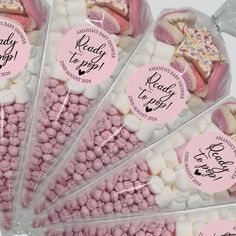 pink and white candies in cello bags with labels for candy to pop on them