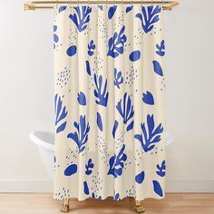 a shower curtain with blue and white leaves on it