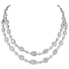 A beautiful diamond necklace! Multiple shaped large diamonds each surrounded by smaller white round brilliants. 31.85 carats of pear, marquise, trillion, and emerald cut center diamonds surrounded by 16.22 carats of round brilliant diamond halos and diamond links. A total of 48.07 carats! F/G VS/SI. The center diamonds average over 1 carat each! 18k white gold Beautiful Diamond Necklace, Sapphire Diamond Pendant, Antique Necklaces, Marquise Shape Diamond, Gold Diamond Earrings Studs, Diamond Cluster Earrings, Gold Diamond Studs, Bling Necklace, Swirl Earrings