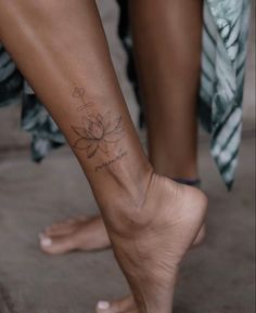 a woman's foot with a flower tattoo on it