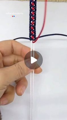 someone is working on something that looks like a string art project with beads and thread