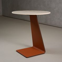 a white table with an orange base on the floor