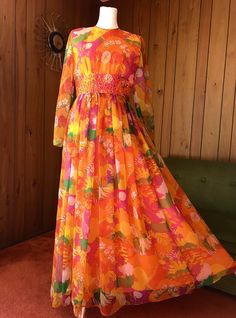 Beautiful party gown with the most psychedelic farm scene print - lovely flowers, trees, foliage and birds in vibrant shades of orange, yellow, pink and green - waistline beaded embellishments and zíper in the back. Size Medium Measurements in inches of garment laid flat: Shoulders 15' Bust 18' Waist 14' Hips up to 19' Length 56' Great Vintage condition! Please message if you have any questions. Multicolor Spring Maxi Dress For Fiesta, Multicolor Maxi Dress For Spring Fiesta, Spring Fiesta Multicolor Maxi Dress, Vintage Orange Dress For Festival, Beaded Embellishments, Gloria Steinem, Farm Scene, Party Gown, Sun Valley