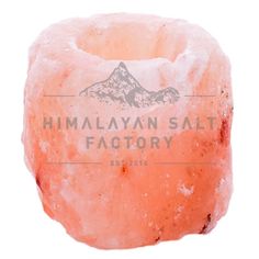 the himalayan salt factory logo is shown on top of an orange piece of rock, with mountains in the background