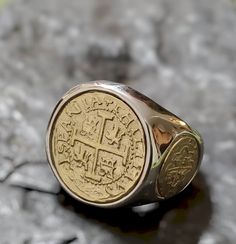 This ring is absolutely stunning and very unique.  The band is solid sterling silver,  and the center, and two side coins are made from the silver bars recovered from the Atocha and comes with a certificate stating that. I use a 14kt gold plating on the coins to give this piece a striking contrast. Bronze 14k Gold Ring, Collectible Sterling Silver Yellow Gold Rings, 14k Gold Bronze Ring Jewelry, Silver 14k Gold Ring For Commemoration, Heirloom 14k Gold Jewelry Stamped 925, Gold Engraved Signet Ring For Commemoration, Nickel Free 14k Gold Rings, Classic Collectible Coin Rings, Classic Tarnish-resistant Collectible Jewelry