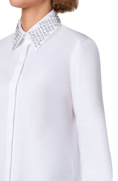 Faceted, round-cut rhinestones pattern the removable point collar on this crisp button-up shirt tailored with a hidden placket and back pleat. Hidden-button placket Band collar; removable point collar Long sleeves with button cuffs Side slits Drop-tail hem 100% cotton Dry clean Imported Designer Clothing Elegant Workwear Tops With Embellished Collar, Elegant Tops With Embellished Collar For Work, Elegant Long Sleeve Shirt With Rhinestones, White Blouse With Embellished Collar For Work, Formal Long Sleeve Shirt With Embellished Collar, Elegant Formal Shirt With Embellished Collar, Classic Embellished Collar Tops For Workwear, Classic Workwear Tops With Embellished Collar, Classic Tops With Embellished Collar For Workwear