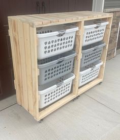 three storage bins are stacked on top of each other in front of a garage door