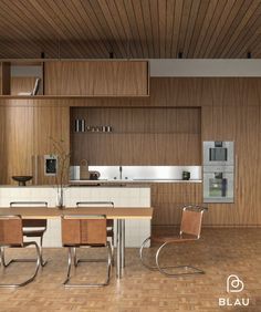 a modern kitchen with wood paneling and stainless steel appliances in the center, along with a dining table surrounded by chairs