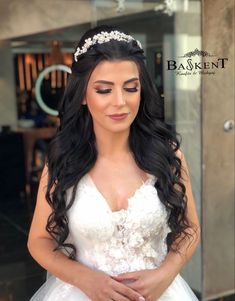 a woman in a wedding dress is posing for the camera with her hands on her hips