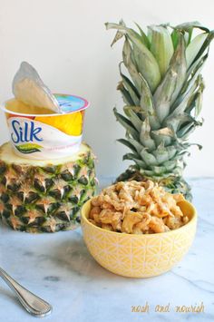 a bowl of cereal next to a pineapple