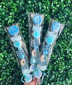 four blue and white candy lollipops in cellophane bags