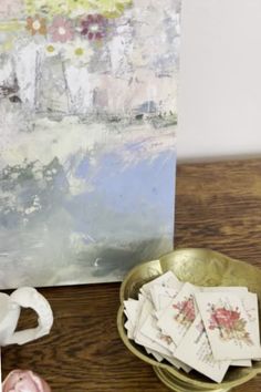 a table topped with lots of cards and vases