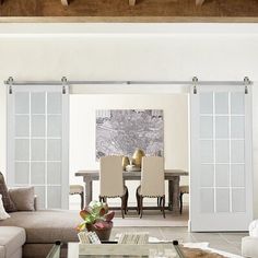 a living room filled with furniture and sliding glass doors leading to a dining room area