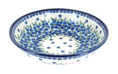 a blue and white bowl with flowers on the inside, sitting in front of a white background