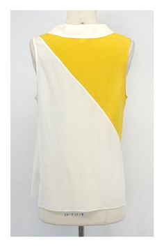 Size 10 Yellow and white colorblocked Dyad tank blouse 100% Silk Semi-sheer Pulls on Draped neckline with button details Shoulder to shoulder 13" Bust 38" Waist 39" Total length 25.25"