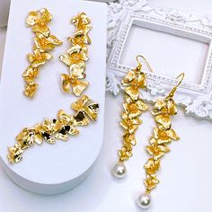 Size: 58x15.5x4mm Material: Brass, 18K Gold Plated Earrings 82x18x8mm Material: Charms: Brass, 18K Gold Plated                  Earring Hooks: Iron                   Pearl Charms: Brass, Plastic, 18K Gold Plated Points to note when purchasing. *Since this is an imported product, there may be scratches, burrs, uneven color, and differences in color due to the manufacturing process. We do not use defective products, but please do not consider if you are looking for perfection. *Depending on your device and viewing environment, the color and texture of the photo may look slightly different from the actual product. *If the delivered product is damaged, defective, or missing, please contact us within 3 days after receiving the product. We will take immediate action after confirming the facts. P Luxury Flower Charm Drop Earrings, Luxury Wedding Flower Charm Earrings, Luxury Gold Plated Jewelry With Flower Charm, Luxury Flower Charm Earrings, Earring Charms, Brass Charms, Pearl Charms, Earring Hooks, Orchid Flower