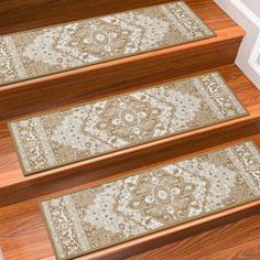 three rugs on the steps leading up to a door