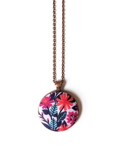 This handmade pink flowers pendant necklace is so beautiful! Such a bold and cheerful design in mood-boosting hues, it would make a lovely handmade gift! -The pendant is handmade with a fantastic, maximal pattern of bright magenta and coral colored flowers with aqua leaves on a light pink background. I designed the fabric myself and had it digitally printed so the necklace is truly unique. -18 inch oval link chain (45 cm) in an antique copper color with a lobster clasp -Pendant is 1.5 inch (38mm) -Chain and pendant setting are zinc alloy. The pendant is large, but still incredibly lightweight so it is easy to wear for a long time. -This makes a wonderful gift! For your best friend, mother, sister, that hard-to-shop-for teen, teachers, hair stylists ... or just a treat for yourself! It come Pink Flower Charm Pendant Necklace, Pink Bohemian Necklace With Flower Charm, Bohemian Pink Necklace With Flower Charm, Handmade Pink Pendant Flower Necklace, Floral Print Flower Necklaces For Gifts, Pink Bohemian Flower Pendant Necklace, Bohemian Pink Flower Pendant Necklace, Pink Floral Print Jewelry As Gift, Pastel Pink Flowers