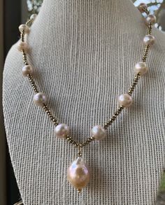 Large, baroque, blush hued pearls with pyrite accents. A beautiful statement piece for any occassion! Elegant Gold Beaded Baroque Pearl Necklaces, Pear-shaped Pearl Jewelry With High Luster, Elegant Baroque Pearl Beaded Necklace For Wedding, Elegant Beaded Bronze Jewelry, Elegant Bronze Beaded Jewelry, Elegant Baroque Pearl Beaded Necklaces, Elegant Pink High Luster Jewelry, Elegant Pink Jewelry With High Luster, Elegant Baroque Pearl Beaded Necklaces With Round Beads