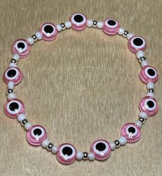 Pink Evil Eyes surrounded by Sterling Silver beads and Mother of Pearl seed beads make up this charming piece! Evil Eye Bracelet Ideas, Girly Bracelets, Buddha Bracelets, Bead Charms Diy, Evil Eyes, Bracelet Ideas, Beaded Bracelets Diy, Eye Bracelet, Evil Eye Bracelet