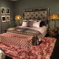 a bedroom with a leopard print bed spread and pink rugs on the floor in front of it