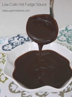 chocolate sauce being poured into a white bowl