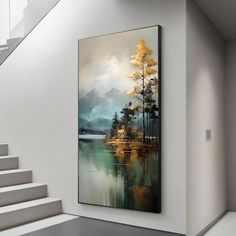 a painting hanging on the wall next to a stair case in a room with white walls