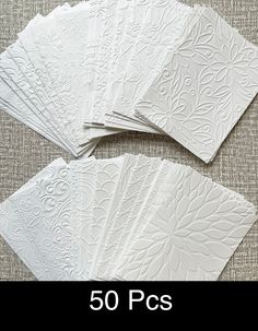 five white paper napkins with intricate designs on the front and back, set of 50