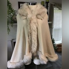 This Beautiful Cape Is Made Of A Soft Knit Fabric Bordered With A Faux Fur. Has A Hook And Eye Closure. Fits Up To A Large.Beautiful Cream Color Winter Wedding Jacket Brides, Fitted Cozy Winter White Outerwear, Cozy Fitted Winter White Outerwear, White Fitted Cozy Outerwear, Chic One-size Winter Outerwear, Cozy Fitted White Outerwear, Cozy One Size Cream Outerwear, Elegant One-size Beige Outerwear, Warm One-size-fits-all Winter Outerwear