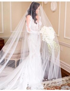 a woman in a white wedding dress and veil