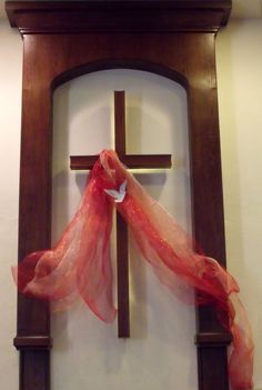 a cross with a red scarf hanging on it