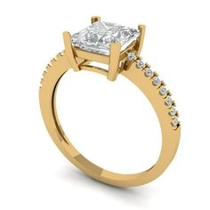 a yellow gold engagement ring with a princess cut diamond in the center and side stones