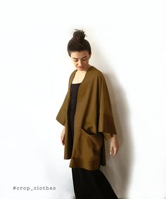 Handmade khaki green boho kimono robe with pockets. Our kimono robe comes in a wide and loose style, one-size-fits all. This is one of our favourite kimono jackets as it is made with a slightly heavier khaki green cotton viscose fabric, giving it a more oversized shirt/ cardigan feel when worn. This is a beautiful simple fabric which creates strong shadows in movement due to its very slight sheen that we are happy shows in the photographs too. Finished with wide arm quarter length sleeves and a Fall Kimono With Relaxed Fit And Kimono Sleeves, Long Fall Kimono With Relaxed Fit, Long Relaxed Fit Kimono For Fall, Long Relaxed Fit Fall Kimono, Fall Long Relaxed Fit Kimono, Oversized Beige Casual Kimono, Fall Season Relaxed Fit Wrap Kimono, Fall Kimono With Pockets And Relaxed Fit, Fall Kimono With Pockets In Relaxed Fit