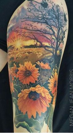 an arm with sunflowers and trees on it