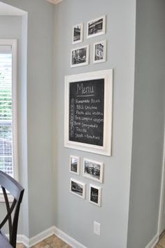 a dining room table and chairs in front of a chalkboard menu