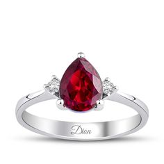 a white gold ring with a pear shaped ruby and diamond accents