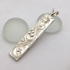 Custom order and Hand made in the Aloha StateHand engraved with Old English design - Hawaiian Maile, Plumeria, and Ocean wave.Sterling Silver1.25" length2mm thickGreat gift for anniversary, wedding or any special occasion.FREE SHIPPING in the USU.S order will be shipped FREE with USPS First Class Mail with tracking. Upgraded shipping - Priority & Express shippings are also available upon checkout International orders will be shipped with USPS International First Class Mail with tracking. Upg Hand Engraved Jewelry, Hawaiian Heirloom Jewelry, Face Jewellery, Gift For Anniversary, Hawaiian Jewelry, English Design, Heirlooms Jewelry, Metal Engraving, Cabochon Jewelry