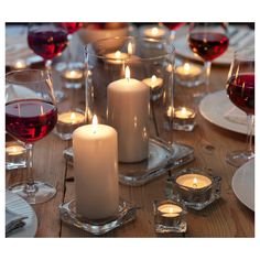 a table with candles and wine glasses on it