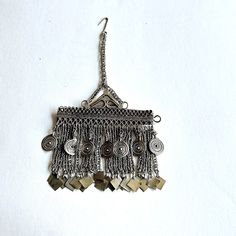 Afghan Kuchi Hair Jewelry or Pendant with.   Vintage Afghan Kuchi Tribal Jewelry with silver dangles Size: 3 inches wide x 6 inches long Mixed metals. Pendant weight 1.2 ozs. Condition:  Very good vintage, good patina. Antique ethnic silver tone metal handmade pendant with silver dangles.  The piece has been used, therefore it shows some oxidation and surface wear. Exact metal content is unknown. Items on Sale are Not Returnable Oxidised Jewellery Afghani, Afghani Jewelry, Amazigh Jewelry, Afghani Necklace, Berber Jewelry Morocco, Vintage Afghan, Handmade Pendant, Body Jewellery, Mixed Metals