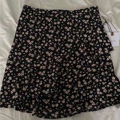 Bought From Dillards Has A Stretchy Waistband Black Floral Print Skirt For Summer, Black Floral Print Mini Bottoms, Black Floral Print Mini Length Bottoms, Black Ruffle Hem Mini Skirt For Spring, Trendy Black Ruffled Skort, Black Ruffled Mini Skirt For Summer, Black Floral Print Mini Skirt, Black Ruffled Mini Skirt For Day Out, Fitted Black Bottoms For Brunch