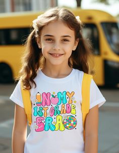 Step into the new school year in style with our exclusive "In My Back to School Era" custom shirts. Perfect for students of all ages, these shirts are designed to make a statement and showcase your unique back-to-school spirit. Embrace the nostalgia of bygone eras while sporting a modern twist with these trendy and personalized back-to-school shirts. Crafted with high-quality materials and attention to detail, these shirts are not just clothing but a reflection of your individuality and enthusiasm for the upcoming academic season. Stand out from the crowd and express yourself confidently with our "In My Back to School Era" shirts - the ultimate blend of retro charm and contemporary flair. Get ready to make a stylish entrance back to school with these one-of-a-kind shirts that capture the e School Spirit Tops With Name Print For School Events, Preppy Short Sleeve School T-shirt, Preppy Short Sleeve T-shirt For School, White School Spirit Shirt For School, White School Spirit Shirt, School Spirit Tops For Daycare And Back To School, Graphic Print Top For End Of School Year, Graphic Print Tops For End Of School Year Events, Daycare Tops For Back To School With School Spirit