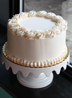 a white cake sitting on top of a window sill