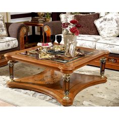 a living room filled with furniture and flowers in vases on top of a coffee table